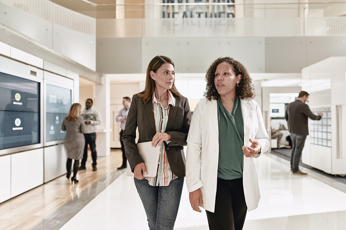 Client and pharmacist walking through the Evernorth Health Services Lab