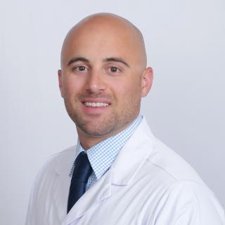 Mike Martinelli, a registered pharmacist with Express Scripts® Pharmacy, in his lab coat.