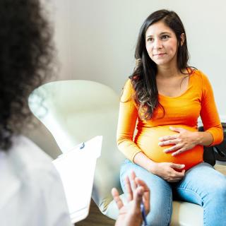 A pregnant woman discusses the safety of her medication with her doctor.