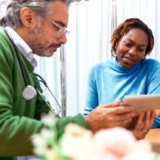 A woman with diabetes goes over her kidney function test results with her doctor.